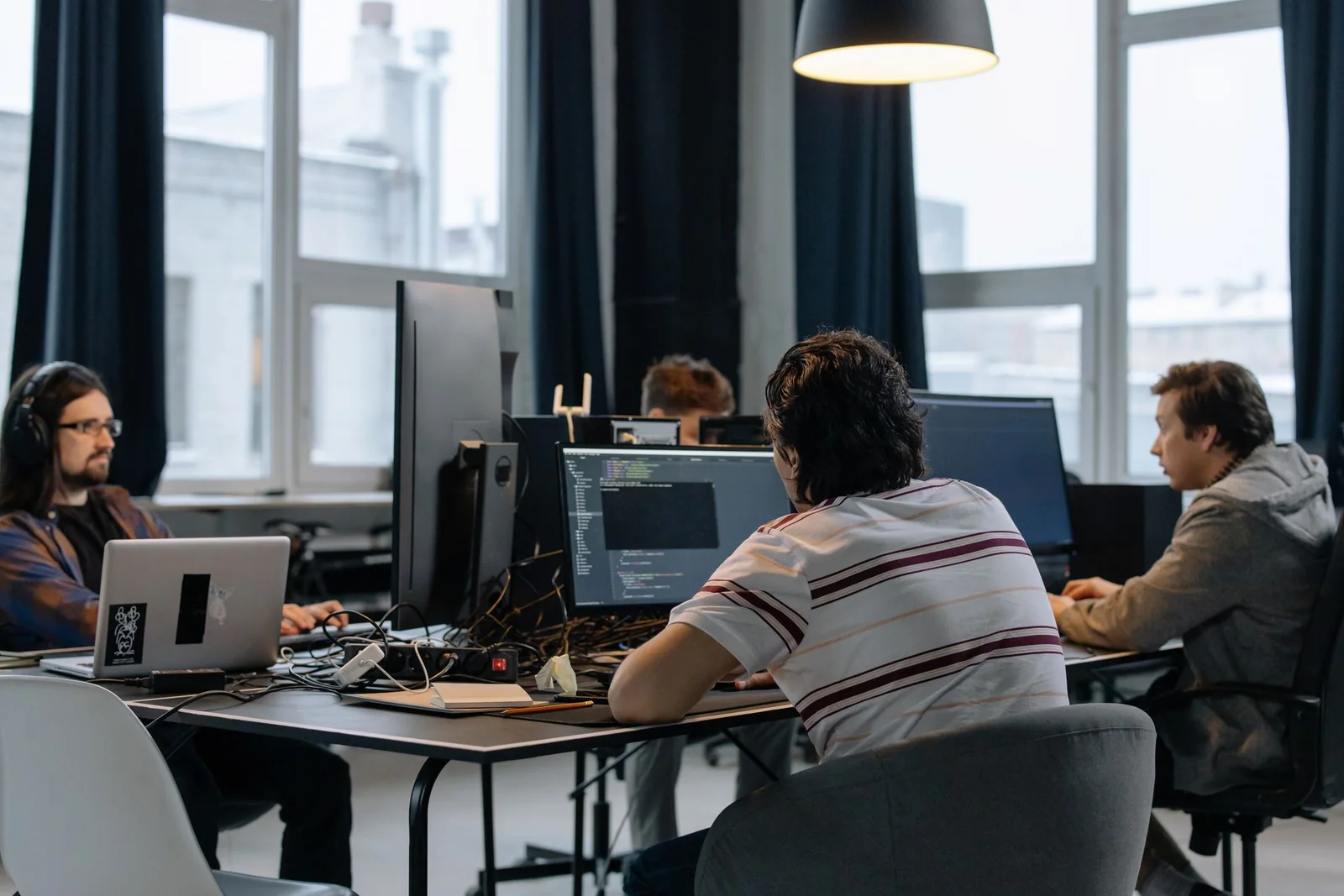 Software professionals collaborating at computer workstations